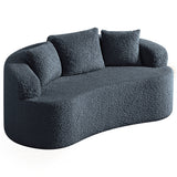 Dark blue boucle sofa with curved arms and three cushions in textured fabric.