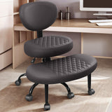 Black adjustable office chair with quilted seat and backrest and white desk in background